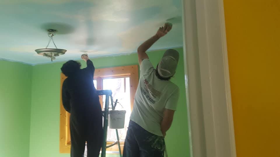 Two ColorTrends painters coating a ceiling on a We Help U Paint job